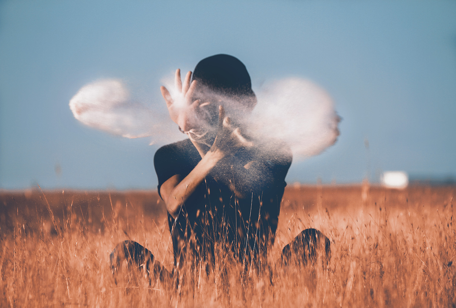 man sitting on brown grass field playing with smoke - magic phrases to decline invitations and avoid burnout