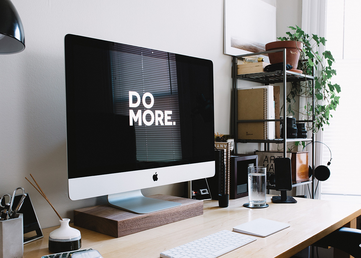 Desktop computer with the words "Do More" on the Screen. What is toxic positivity culture?