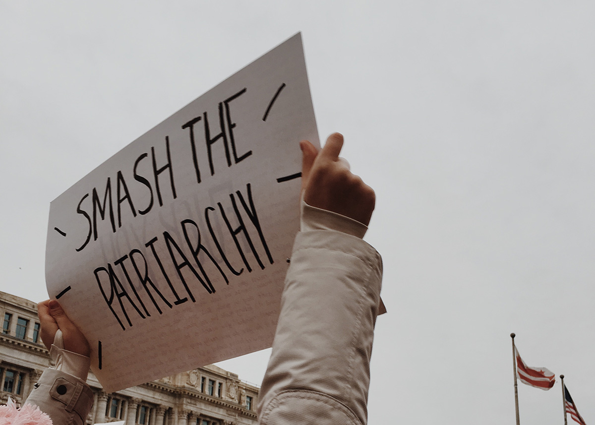 Smash the patriarchy sign being held in protest. Work-life balance