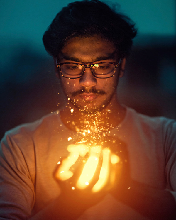 Man holding a light. Learn to burn bright without burning out with burnout coaching