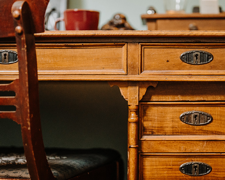 Antique wood desk with chair in the psychotherapy and coaching office of Kathryn Stinson, LPC