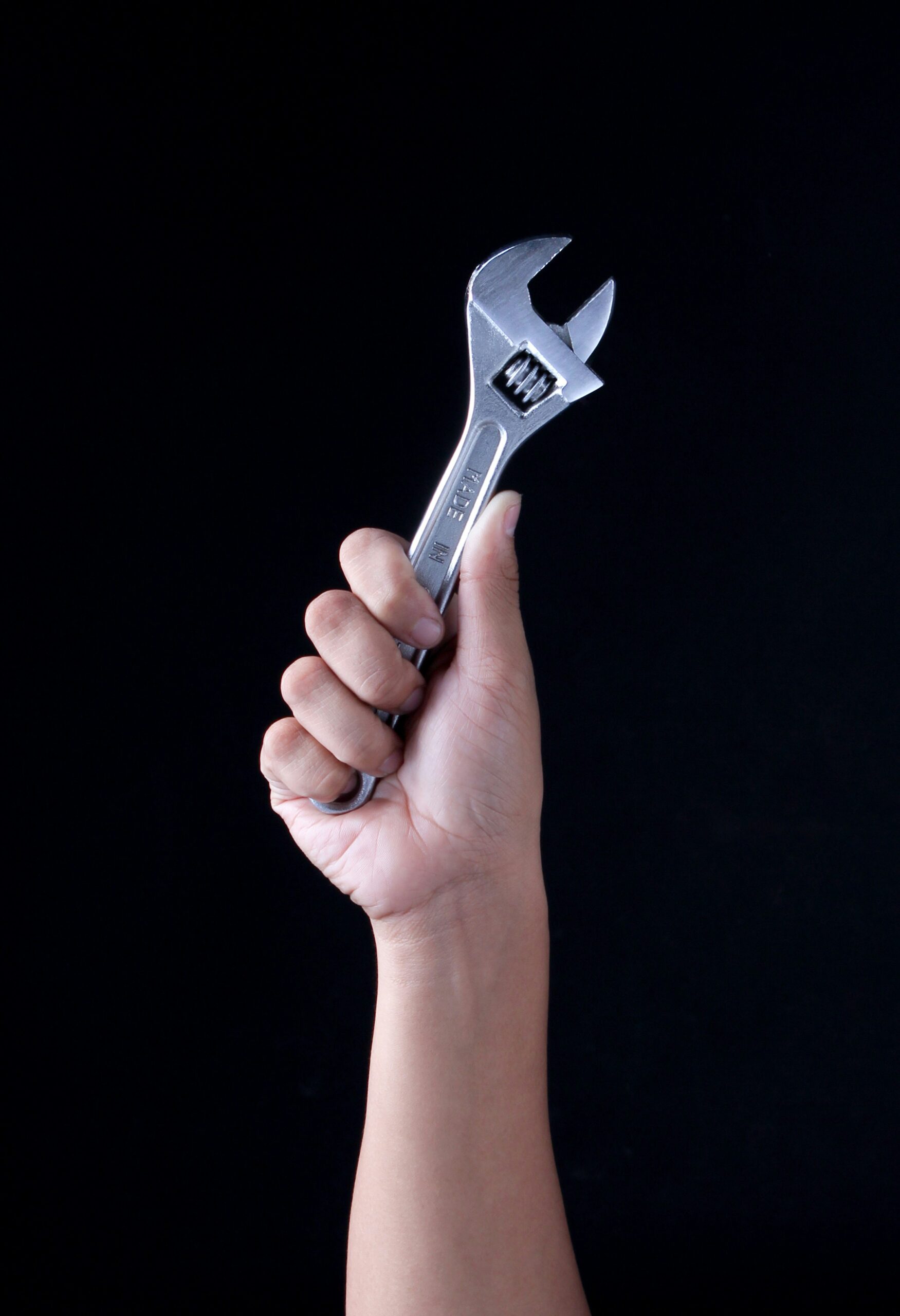 Hand holding wrench